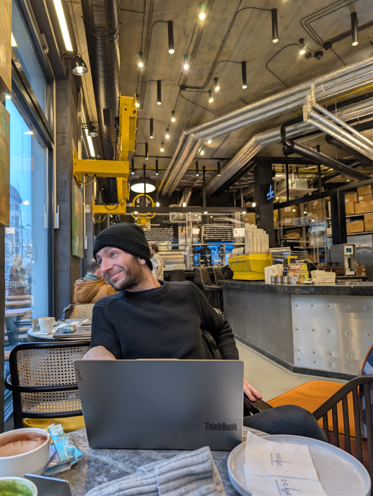 Talal Mando working from a Berlin coffee roastery